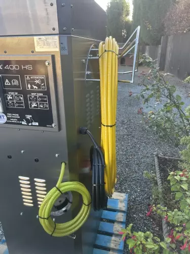 Rear setup showing high-pressure hose reel along with low-pressure and high-pressure chemical lines installed on a Nilfisk 400HS DTE system. Designed for flexible chemical application and improved usability on site.